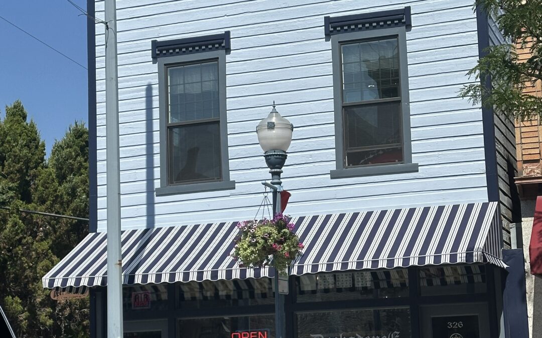 Our historic wooden building has been shored up and repainted including the restoration of the facia. It is shown here with it's light windy blue main color, anchors aweigh dark blue trim and grays harbor accents.