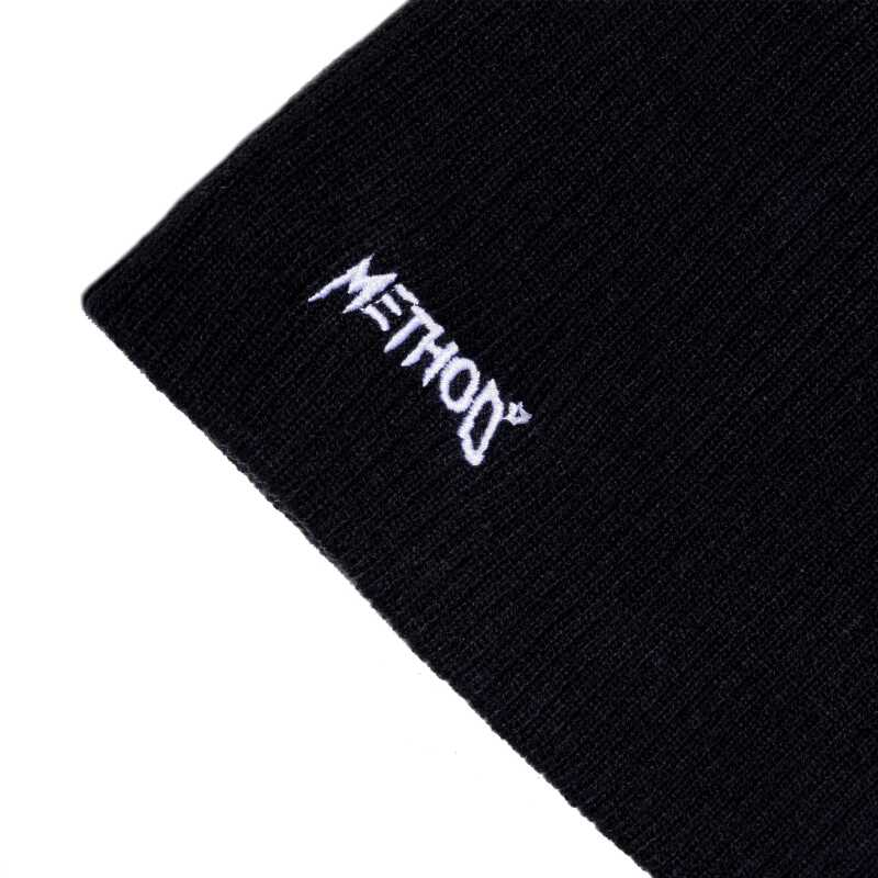 A black knit balaclava with a Method star logo on the front.