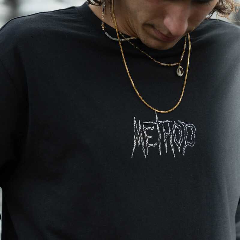 A black long-sleeve t-shirt with the Method Vortex logo on the chest.