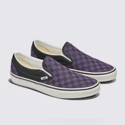 Black and purple checkered Vans Classic Slip-On shoes.